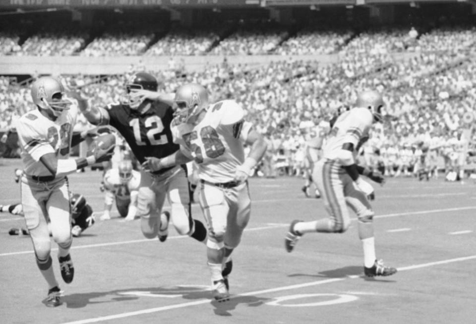 Pittsburgh Steelers quarterback Terry Bradshaw (12) chases down the Houston Oilers player who intercepted him in 1970. (AP)