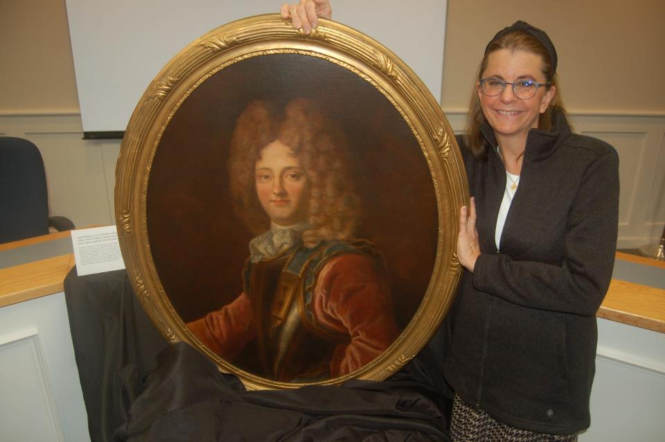 Art restorer Debra Dickinson with the painting of the Duke of Orleans.