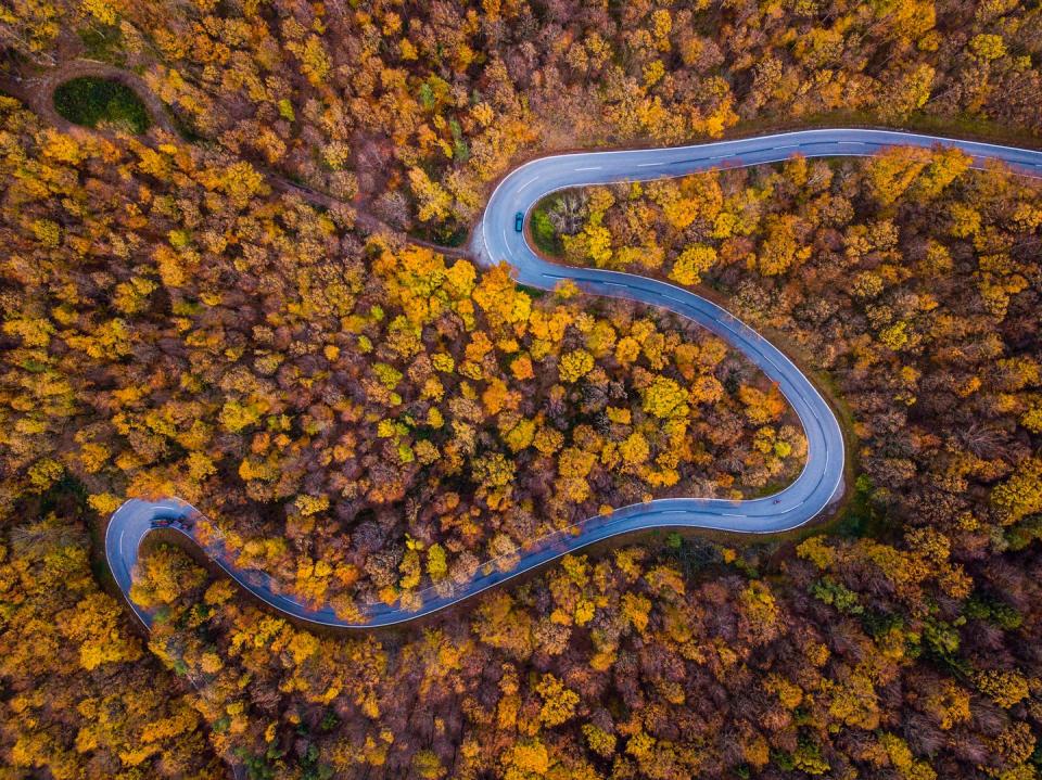 <p>A winding road flows down an undisclosed mountainside. </p>