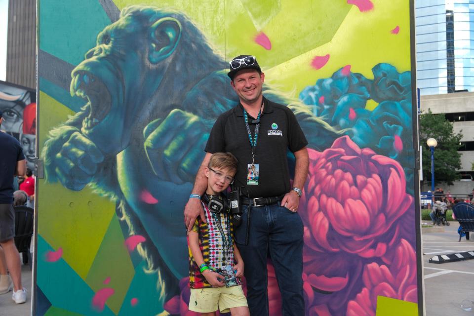Founder of Hoodoo Mural Festival Andrew Hall and his daughter Wells standing in front of a mural by Carlos B Saturday at the 4th annual Hoodoo Music Festival in downtown Amarillo.