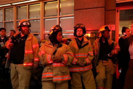 Emergency first responders are seen outside 787 7th Avenue in midtown Manhattan where helicopter crashed in New York