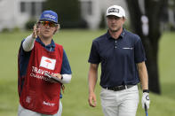 Mackenzie Hughes, right, of Canada, talks to his caddie before taking his tee shot on the third hole during the first round of the Travelers Championship golf tournament at TPC River Highlands, Thursday, June 25, 2020, in Cromwell, Conn. (AP Photo/Frank Franklin II)