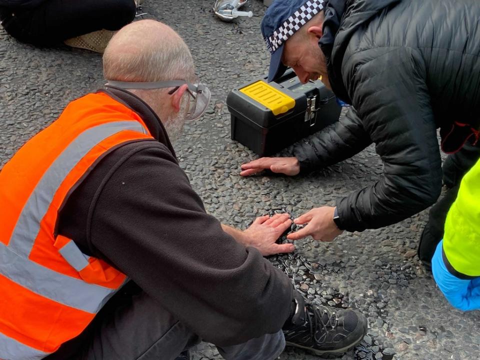 Insulate Britain activists glue themselves to ground outside parliament (Thomas Kingsley / The Independent)