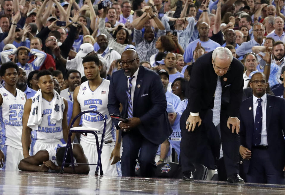 FILE - In this April 4, 2016, file photo, North Carolina head coach Roy Williams, right and his players on the bench react after the NCAA Final Four tournament college basketball championship game against Villanova, in Houston. Villanova won 77-74. (AP Photo/David J. Phillip)