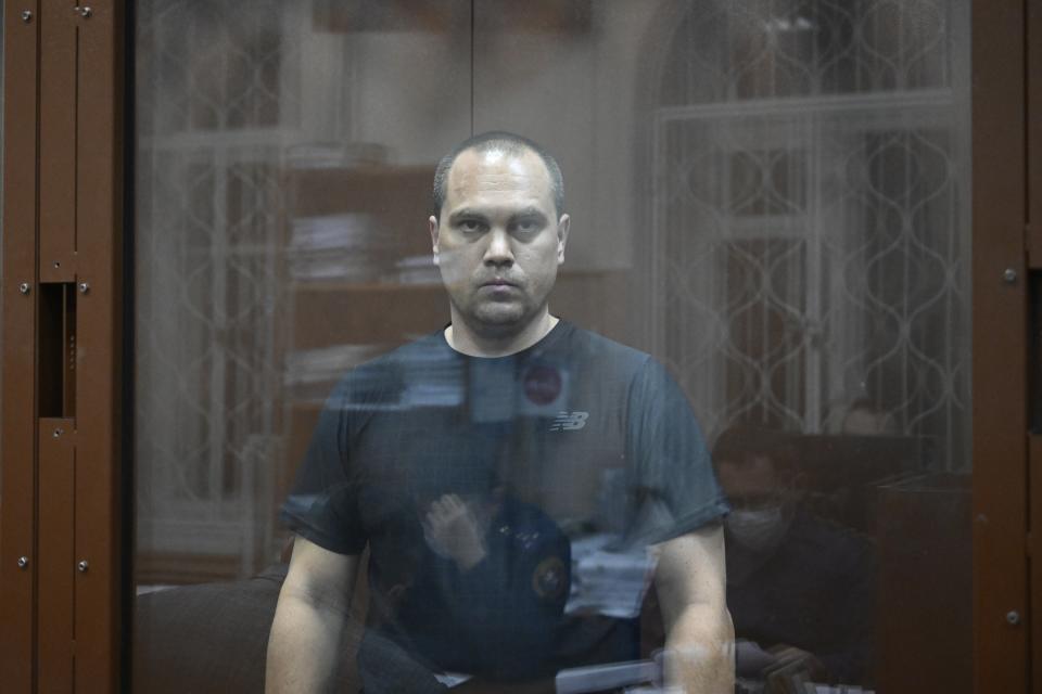 FILE – Vadim Kobzev, a lawyer for Alexei Navalny, stands in a defendants’ cage in a court in Moscow, Russia, on Friday, Oct. 13, 2023. Kobzev was arrested on charges of involvement with an extremist organization, which associates of the opposition leader said was a way to keep him isolated before his death in prison. (AP Photo, File)