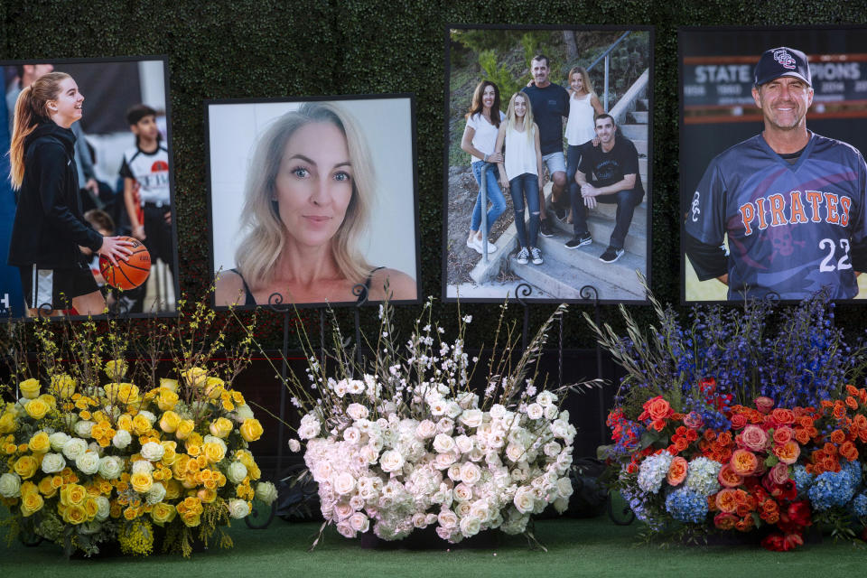 FILE - In this Feb. 10, 2020, file photo, flowers and photos honor members of the Altobelli family outside Angel Stadium in Anaheim, Calif. Coach John Altobelli, 56, far right, his wife, Keri, 43, second from left, and his daughter Alyssa, 13, left, died in a helicopter crash on Jan. 26 in Calabasas, Calif. Autopsy reports released Friday, May 15, 2020, show that the pilot who flew basketball icon Kobe Bryant did not have drugs or alcohol in his system when the helicopter crashed in Southern California in January, killing all nine aboard. The causes of death for Bryant, his 13-year-old daughter Gianna, pilot Ara Zobayan and the others have been ruled blunt force trauma. Federal authorities are still investigating the Jan. 26 incident where the chopper crashed into the Calabasas hillsides. (AP Photo/Damian Dovarganes, File)