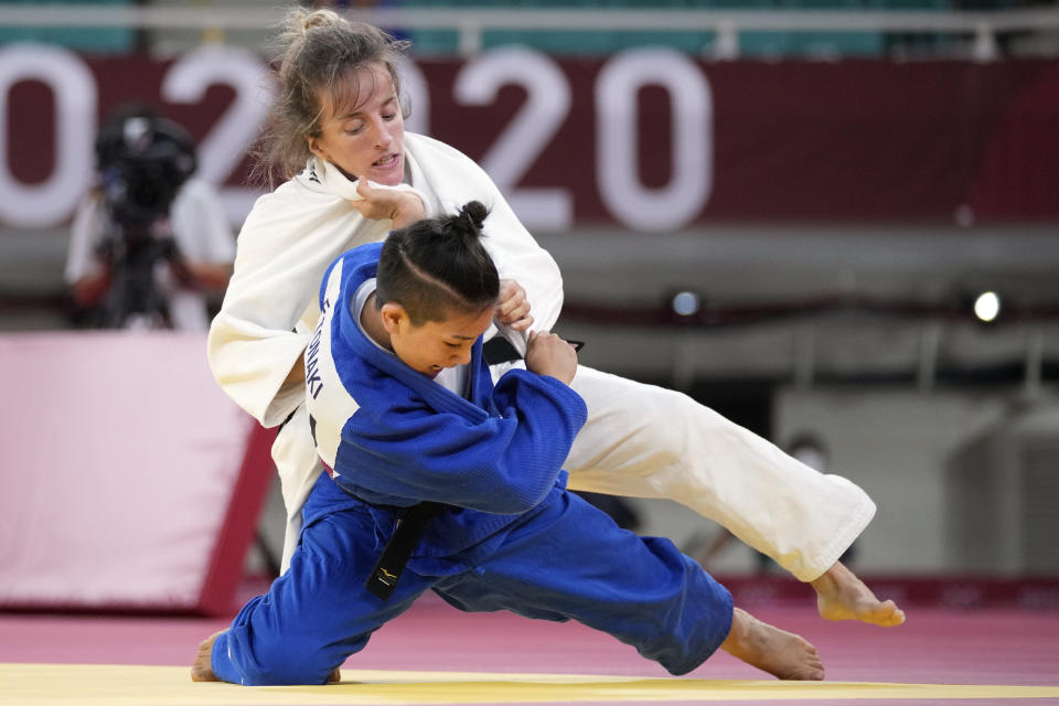 Distria Krasniqi of Kosovo, top, and Funa Tonaki of Japan compete during their women's -48kg championship judo match at the 2020 Summer Olympics, Saturday, July 24, 2021, in Tokyo, Japan. (AP Photo/Vincent Thian)