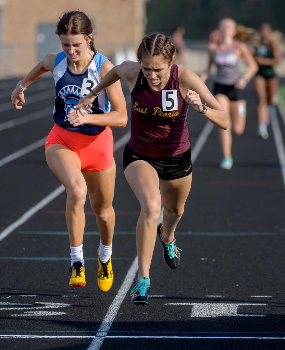 East Peoria's Kerrigan Vandel, right, and Olympia's Anna Bieber make it close at the finish line for second and third place respectively in the 800-meter run during the Class 2A Girls Dunlap Sectional track and field meet Wednesday, May 11, 2022 at Dunlap High School.