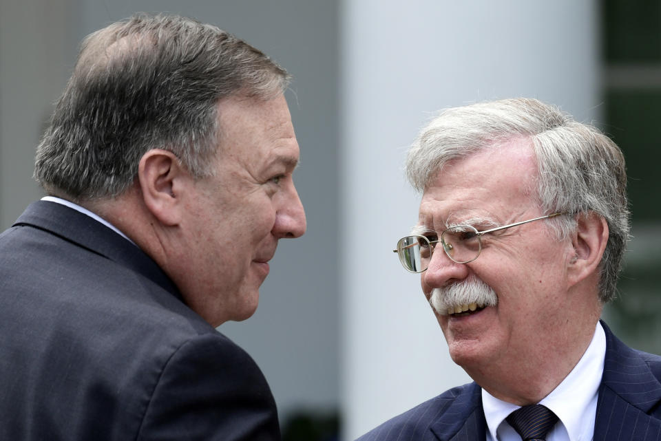 FILE - In this June 7, 2018, file photo, Secretary of State Mike Pompeo, left, and national security adviser John Bolton, right, talk before the start of a news conference with President Donald Trump and Japanese Prime Minister Shinzo Abe in the Rose Garden of the White House in Washington. In President Donald Trump’s Washington, matters of war and peace are decided in 280-character bursts. It’s up to John Bolton to massage them into a foreign policy. (AP Photo/Susan Walsh, File)