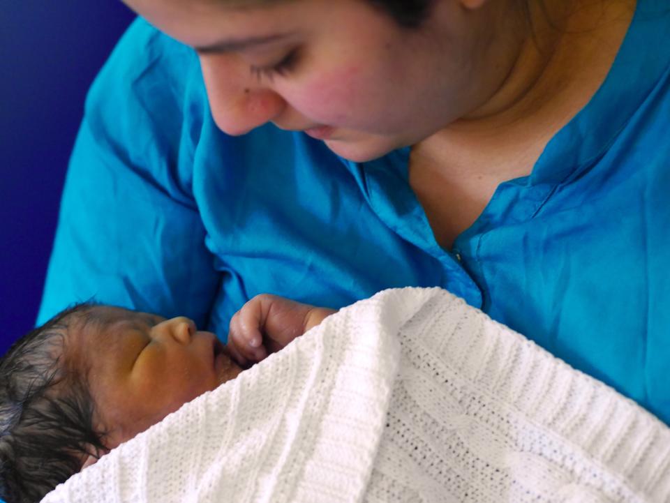 Sanam Saleh holding her baby son Idrees