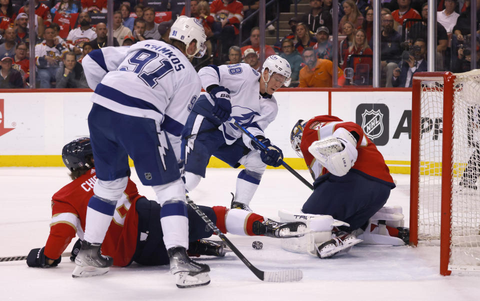 Florida Panthers defenseman Ben Chiarot (8) looks on as Panthers goaltender Sergei Bobrovsky (72) makes a stop against Tampa Bay Lightning center Steven Stamkos (91) and left wing Ondrej Palat (18) during the first period of Game 1 of an NHL hockey second-round playoff series Tuesday, May 17, 2022, in Sunrise, Fla. (AP Photo/Reinhold Matay)