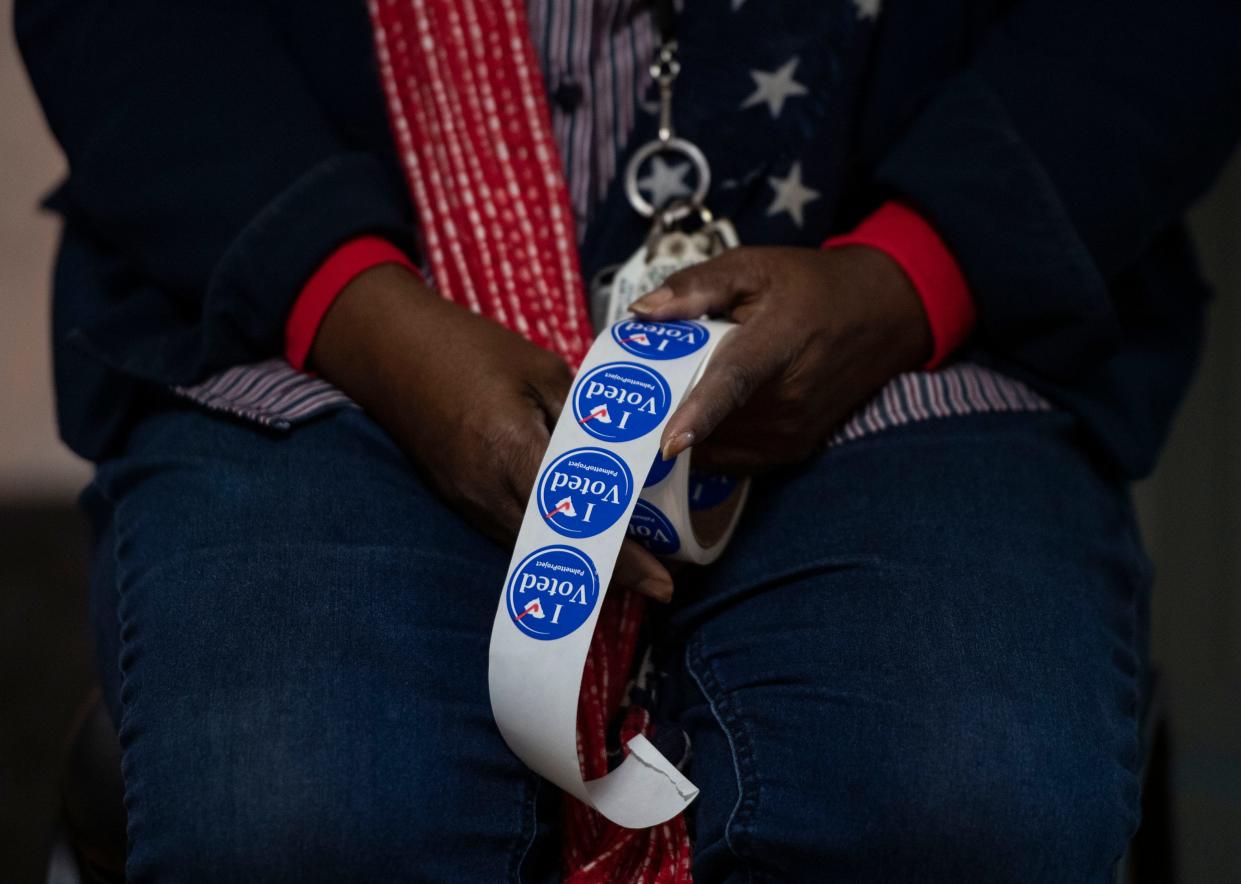 Yvonne Reader, an election official, prepares to hand out stickers to voters at Mauldin Cultural Center, in Mauldin, Tuesday, November 16, 2021. Voters hit the polls for the Seat 5 runoff on Mauldin City Council. Incumbent Dale Black faces challenger Frank Allgood, neither of whom had 50% of the vote at the Nov. 2 election.