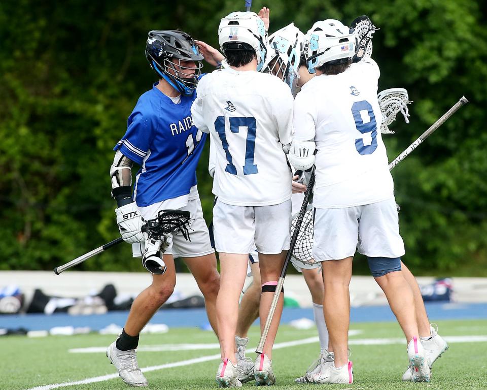 Dover-Sherborn's Wyatt Pastore congratulates Sandwich goalie Shane Corcoran after they loss to Sandwich 11-8 in the Division 4 state semifinal game at Scituate High School on Wednesday, June 14, 2023. 