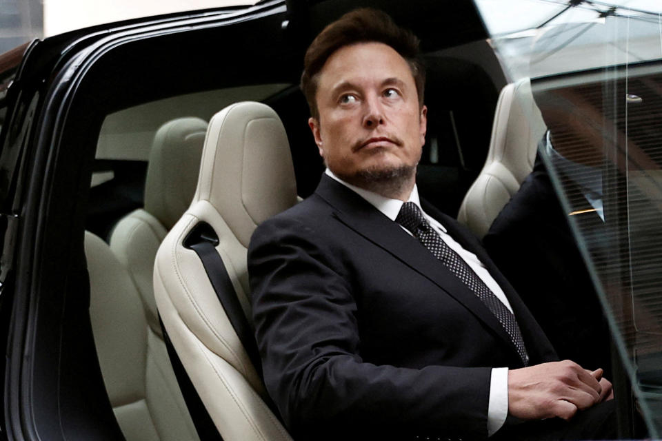 FILE PHOTO: Tesla CEO Elon Musk gets into a Tesla car as he leaves a hotel in Beijing, China, May 31, 2023. REUTERS/Tingshu Wang/File Photo