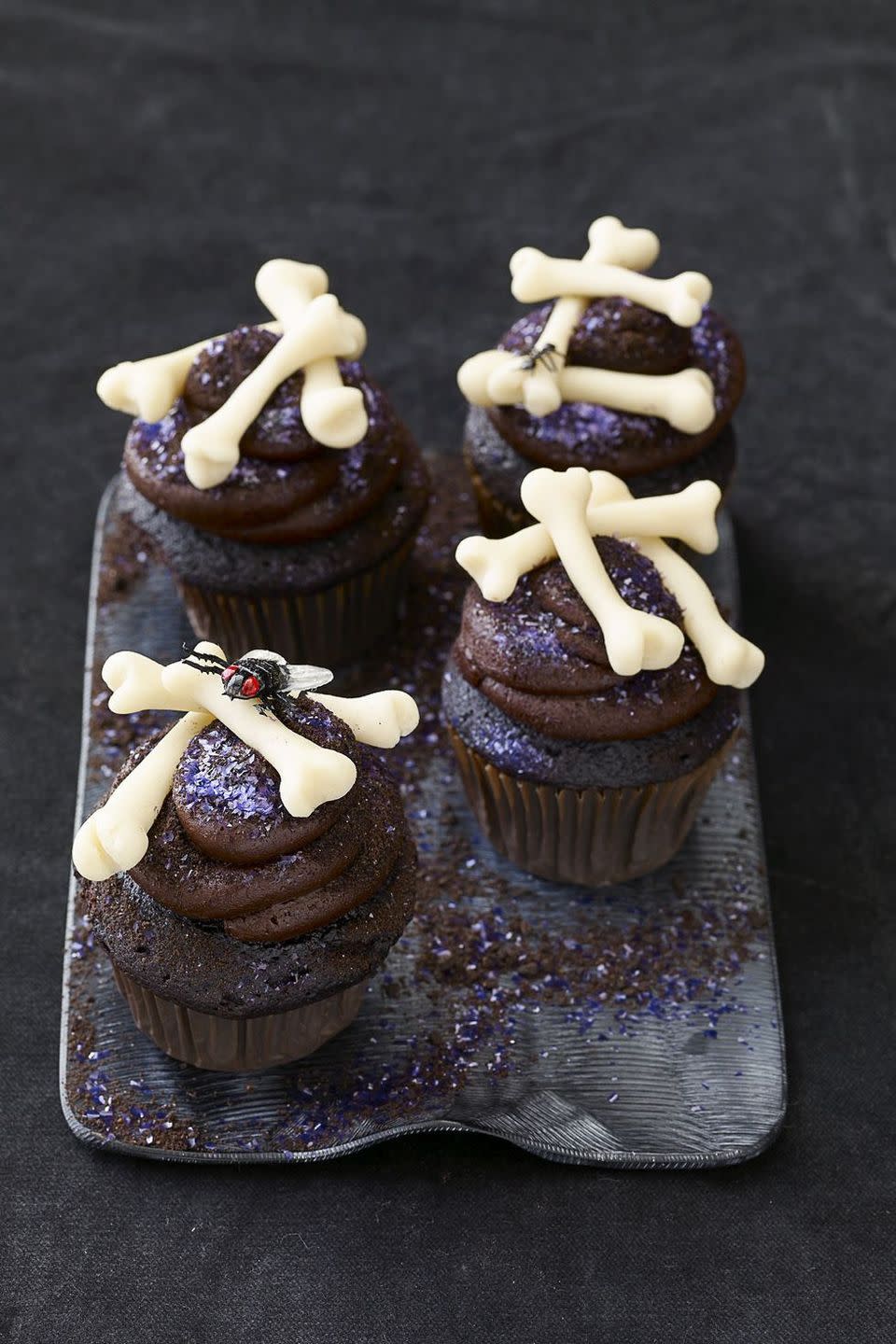 <p>This sweet, chocolatey cake has an other-worldly exterior complete with marzipan bones and edible glitter. There's a tasty reward waiting for those brave enough to take a bite.</p><p><em><a href="https://www.womansday.com/food-recipes/food-drinks/recipes/a22259/chocolate-voodoo-cakes-halloween-recipes/" rel="nofollow noopener" target="_blank" data-ylk="slk:Get the recipe for Chocolate Voodoo Cake;elm:context_link;itc:0;sec:content-canvas" class="link ">Get the recipe for Chocolate Voodoo Cake</a>.</em></p>