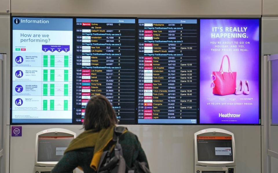 A passenger looks at a departures board at Heathrow as leisure flights to the US resume (Steve Parsons/PA) (PA Wire)