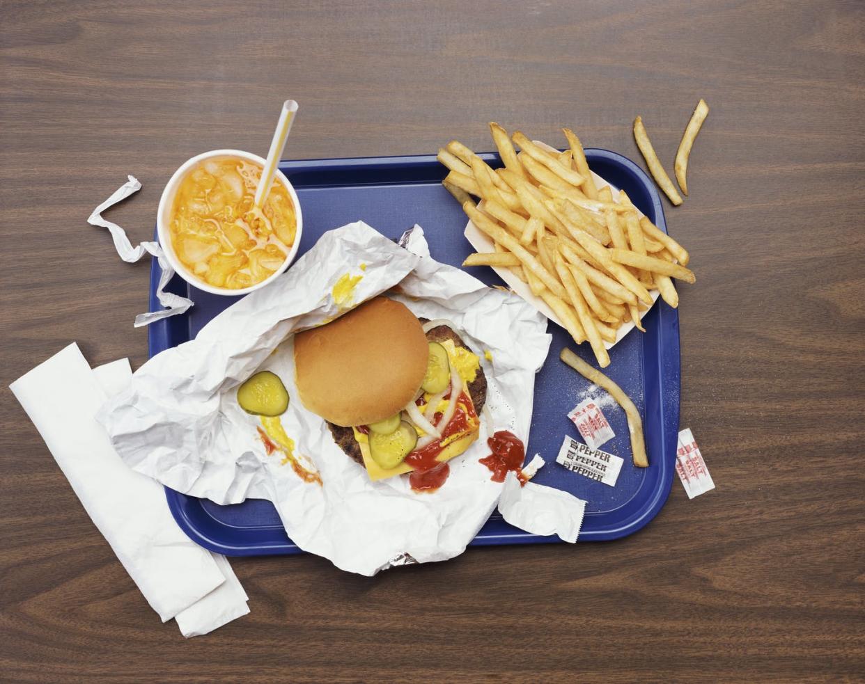 <span class="caption">Many Americans find comfort in familiar fast-food meals, but they undercut local food security.</span> <span class="attribution"><a class="link " href="https://www.gettyimages.com/detail/photo/elevated-view-of-a-tray-with-fries-a-hamburger-and-royalty-free-image/dv1897014" rel="nofollow noopener" target="_blank" data-ylk="slk:Getty Images;elm:context_link;itc:0;sec:content-canvas">Getty Images</a></span>