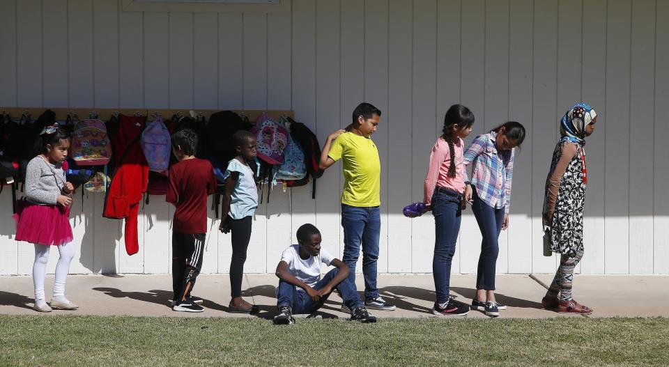 Students at Valencia Newcomer School wait to change classes Thursday, Oct. 17, 2019, in Phoenix. Children from around the world are learning the English skills and American classroom customs they need to succeed at so-called newcomer schools. Valencia Newcomer School in Phoenix is among a handful of such public schools in the United States dedicated exclusively to helping some of the thousands of children who arrive in the country annually. (AP Photo/Ross D. Franklin)