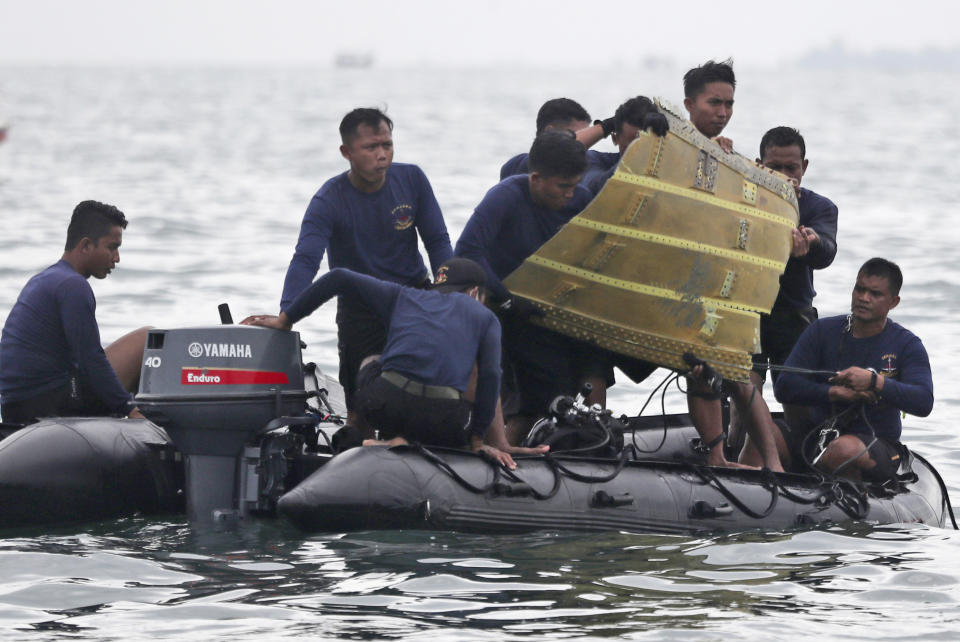 FILE - In this Jan. 10, 2021, file photo, Indonesian Navy divers pull out a part of an airplane out of the water during a search operation for a Sriwijaya Air passenger jet that crashed into the sea near Jakarta, Indonesia. A malfunctioning automatic throttle may have caused the pilots of the Sriwijaya Air jet to lose control, leading to the plane's plunge into the Java Sea last month, Indonesian investigators said Wednesday, Feb. 10, 2021. (AP Photo/Achmad Ibrahim, File)