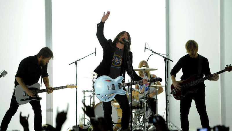 Dave Grohl, center, and the Foo Fighters performs at the 54th annual Grammy Awards on Sunday, Feb. 12, 2012, in Los Angeles. A year after Taylor Hawkins’ death, the Foo Fighters are going on tour.