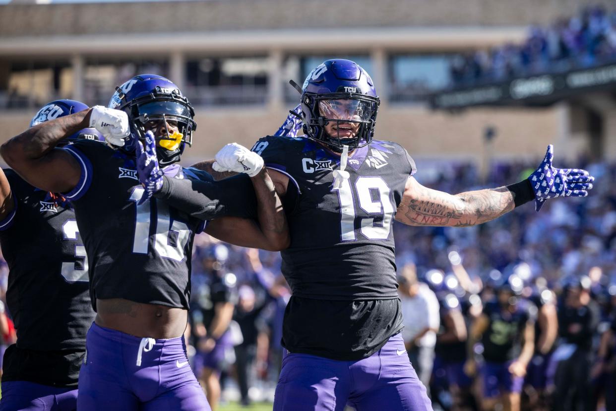 TCU Horned Frogs tight end Jared Wiley (19) and wide receiver Dylan Wright (16) celebrate after Wiley scores a touchdown against the Brigham Young Cougars during the game at Amon G. Carter Stadium.
