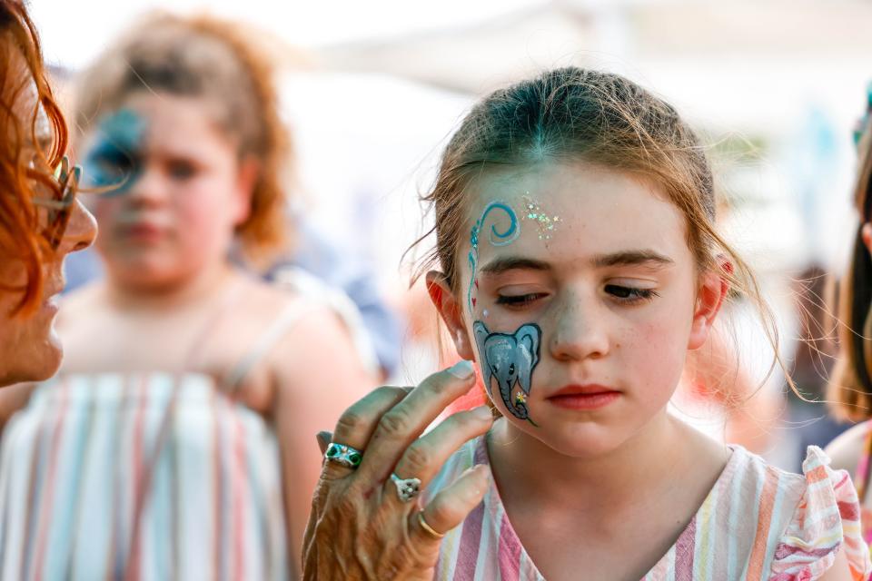 Maren McCormick gets her face painted at the Paseo Art Festival in Oklahoma City, on Saturday, May 27, 2023.