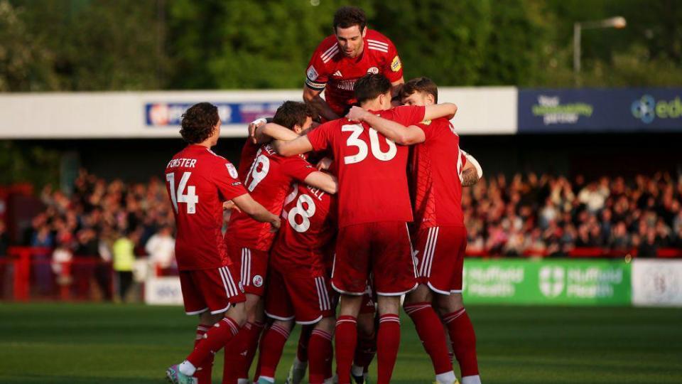Crawley players celebrate a goal in their first leg play-off v MK Dons