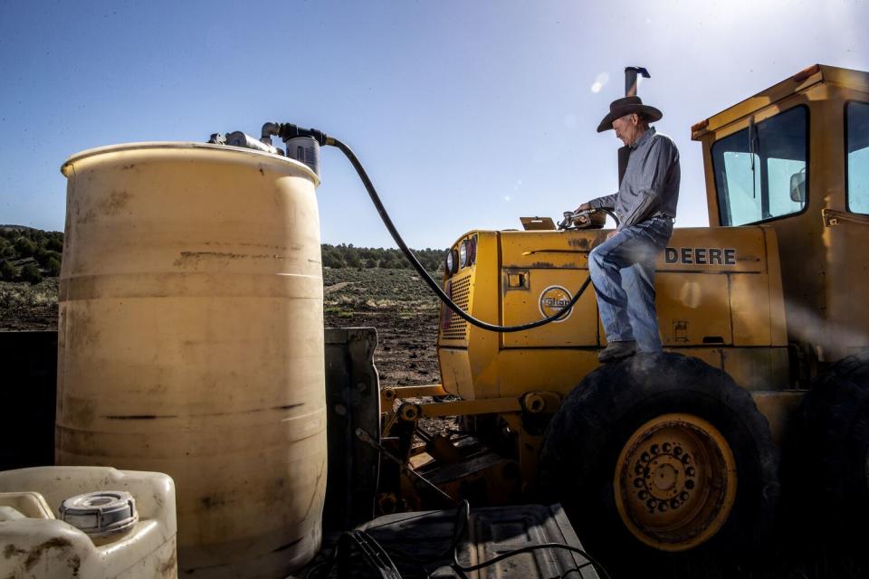 Brent Hafen fuels up a motor grader on his ranchland.