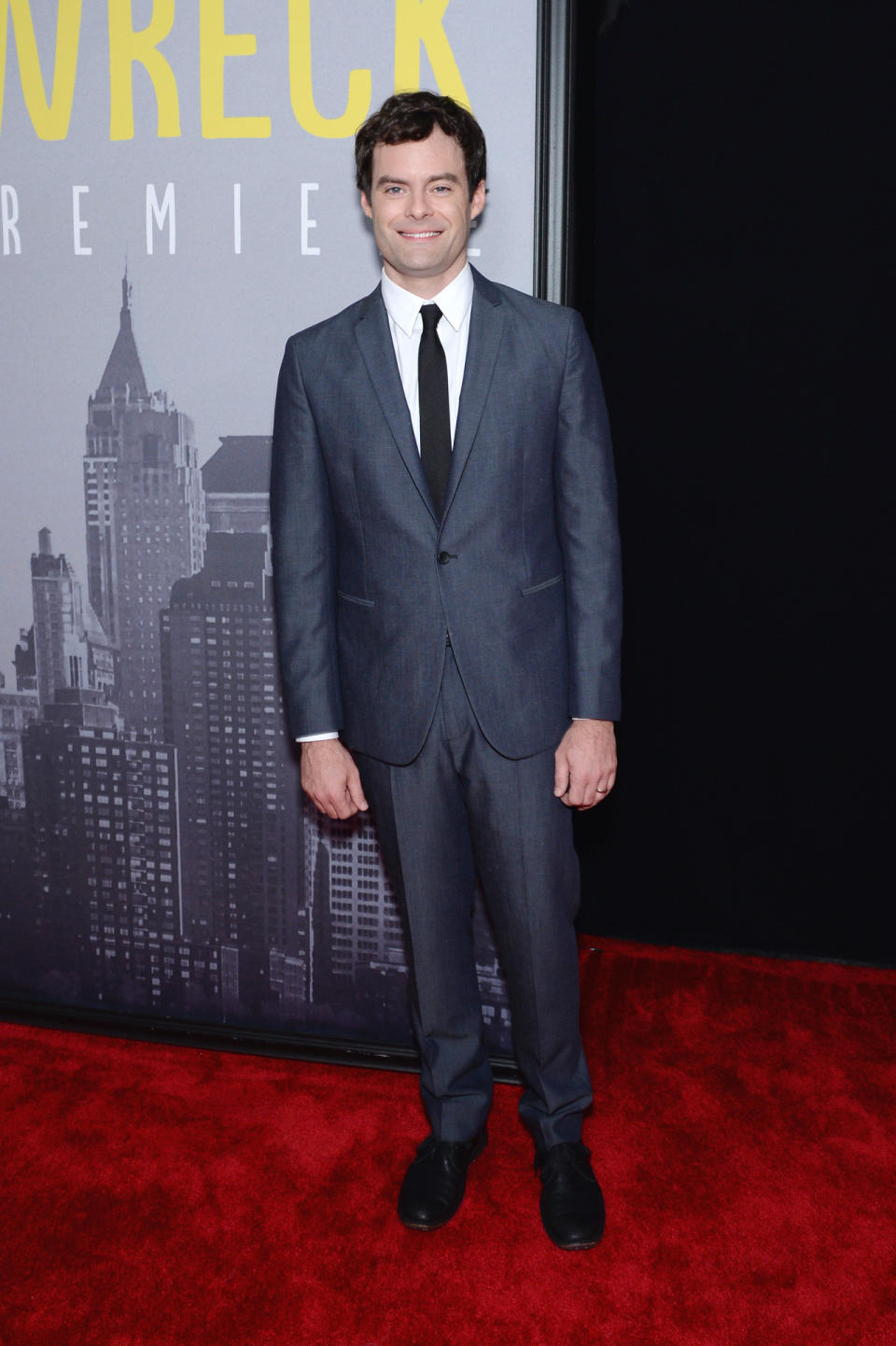 Bill Hader in a slate blue suit and black tie.