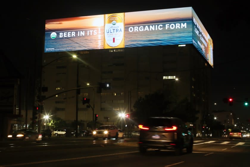 LOS ANGELES, CA - JULY 26: A digital sign is on Sunday, July 26, 2020 in Los Angeles, CA. The light from the billboard streams into neighboring apartments, keeping people up at night. (Dania Maxwell / Los Angeles Times)