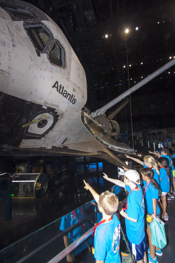 At the Kennedy Space Center Visitor Complex in Florida, Camp Kennedy Space Center participants get an up-close look at the space shuttle Atlantis during a weeklong summer activity for students entering second through ninth grades. Their tour to