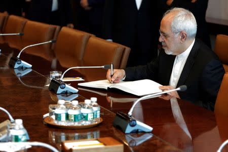 Iran's Foreign Minister Mohammad Javad Zarif signs a ceremonial book before a meeting at theU.N. headquarters in New York City, U.S., July 17, 2017. REUTERS/Lucas Jackson