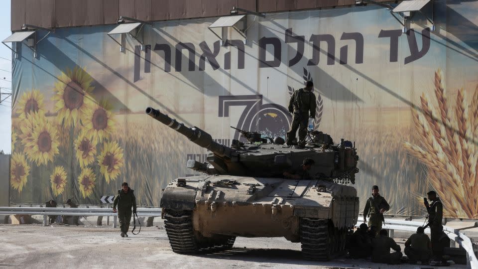 Israeli soldiers gather on and around a tank near Israel's border with the Gaza Strip, in southern Israel on October 15. - Ronen Zvulun/Reuters