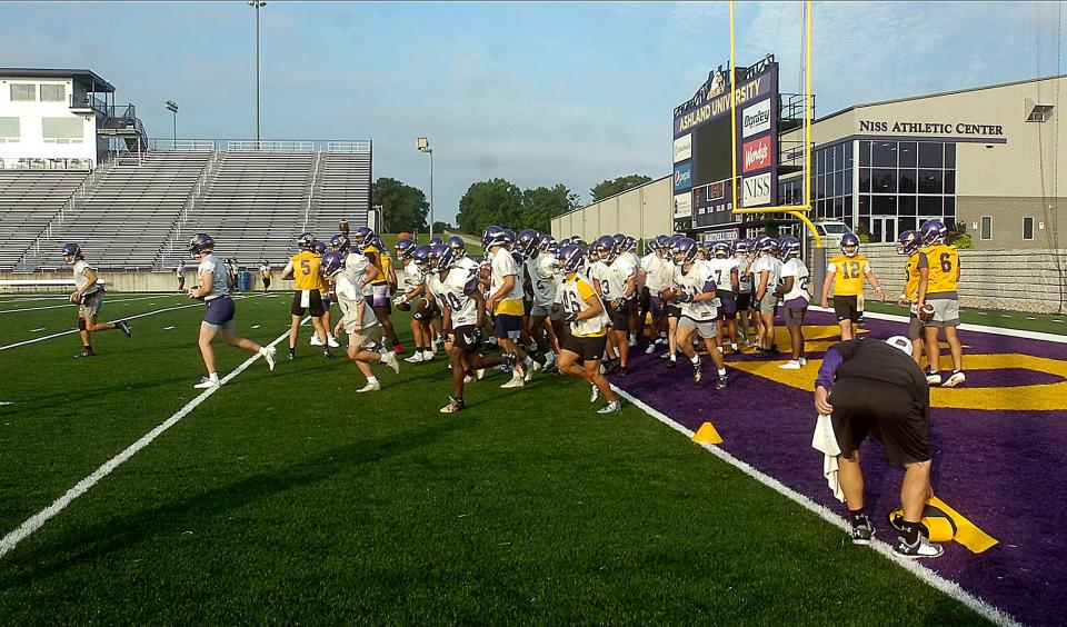 Ashland University football players take part in a drill during the first practice session of training camp Thursday, Aug. 11, 2022.