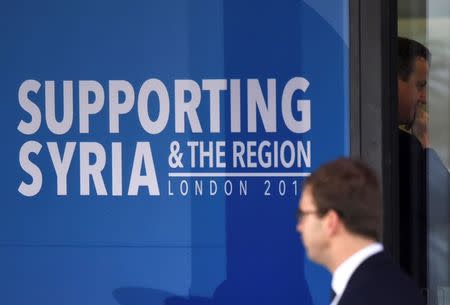 Britain's Prime Minister David Cameron (R) arrives at the donors Conference for Syria in London, Britain February 4, 2016. REUTERS/Toby Melville