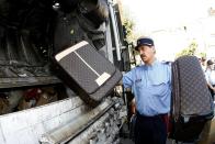 High-end luxury brands like Louis Vuitton are also imitated by clever counterfeiters. These suitcases, shown in Cannes, France as they are being prepared for destruction, are one of the goods seized in connection with the hotbed of counterfeiting that used to take place in that city.