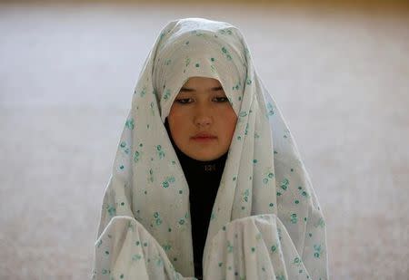 Female soldier Mohazama Najebi, 18, from the Afghan National Army (ANA), prays inside a mosque at the Kabul Military Training Centre (KMTC) in Kabul, Afghanistan, October 26, 2016. REUTERS/Mohammad Ismail