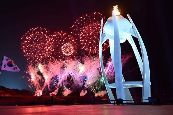 Fireworks explode behind the Olympic flame during the Closing Ceremony of the PyeongChang 2018 Winter Olympic Games at PyeongChang Olympic Stadium on Feb. 25, 2018 in Pyeongchang-gun, South Korea. (Photo by Florien Choblet – Pool/Getty Images)