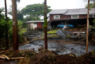 <p>Mud and debris litter a backyard as a result of flooding caused by Hurricane Lane in Hilo, Hawaii, Aug. 25, 2018. (Photo: Terray Sylvester/Reuters) </p>