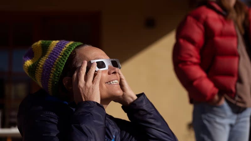 Jill Baillie and Courtney Henley watch an annular solar eclipse in Torrey, Utah, on Saturday, Oct. 14, 2023. A phenomenon known as the "ring of fire" was visible because of the way the sun's edges perfectly surround the moon.