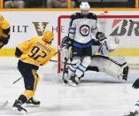 Nov 20, 2017; Nashville, TN, USA; Nashville Predators center Ryan Johansen (92) scores past Winnipeg Jets goalie Connor Hellebuyck (37) during the second period at Bridgestone Arena. Christopher Hanewinckel-USA TODAY Sports