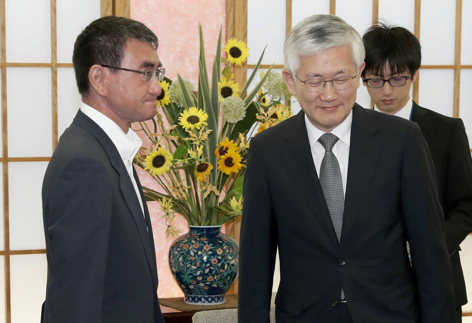 Japan's Foreign Minister Taro Kono meets with South Korean Ambassador to Japan Nam Gwan Pyo, front right, at foreign ministry in Tokyo Friday, July 19, 2019. Japan has summoned South Korea's ambassador to protest Seoul's refusal to join in an arbitration panel to settle a dispute over World War II labor. (Masanobu Kumagai/Kyodo News via AP)