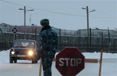 A police officer guards the road in front of the Penal Colony 7, where Mikhail Khodorkovsky was held at, in the village of Segezha near the Finnish border, 300 km (200 miles) south of the Arctic Circle December 20, 2013. REUTERS/Tatyana Makeyeva