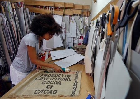 Ivory coast fashion designer Liliane Estievenart, 45, works on cocoa's sacks inside her workshop in Abidjan, Ivory Coast July 22, 2017. REUTERS/Thierry Gouegnon