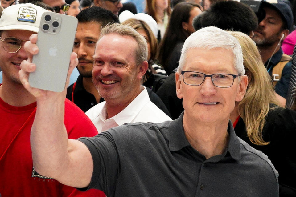 Apple CEO Tim Cook holds a new iPhone 15 Pro during the 'Wonderlust' event at the company's headquarters in Cupertino, California, U.S. September 12, 2023. REUTERS/Loren Elliott