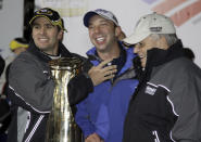 FILE - In this Saturday, Oct. 17, 2009, file photo, Jimmie Johnson, left, jokes with crew chief Chad Knaus, center, and team owner Rick Hendrick, right, after winning the NASCAR Banking 500 Sprint Cup Series auto race at Lowe's Motor Speedway in Concord, N.C. Chad Knaus will move off the pit stand and into a management role with Hendrick Motorsports, ending his crew chief career after seven championships. Hendrick on Tuesday, Sept. 29, 2020, announced Knaus will move to vice president of competition. (AP Photo/Terry Renna, File)