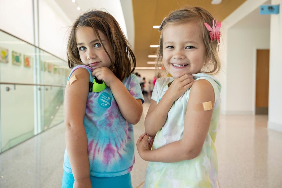 Ansley Dinkler, 4, right, and Camilla Gurrero, 4, show off their Band-Aids after receiving COVID-19 vaccinations on June 21, 2022, in New Orleans.