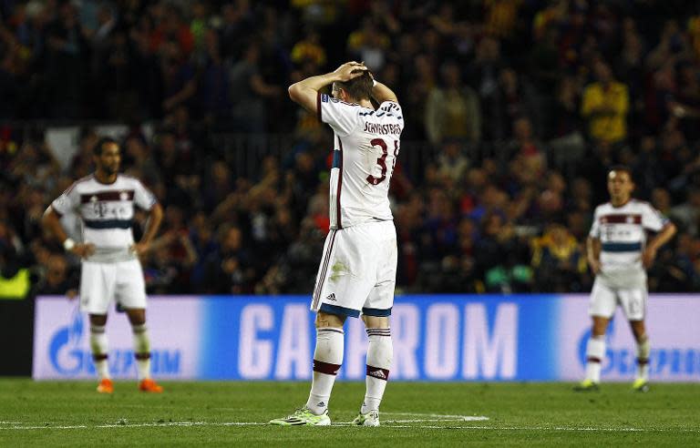 Bayern Munich's Bastian Schweinsteiger (C) reacts after Barcelona score their third goal during the Champions League match at Camp Nou stadium on May 6, 2015