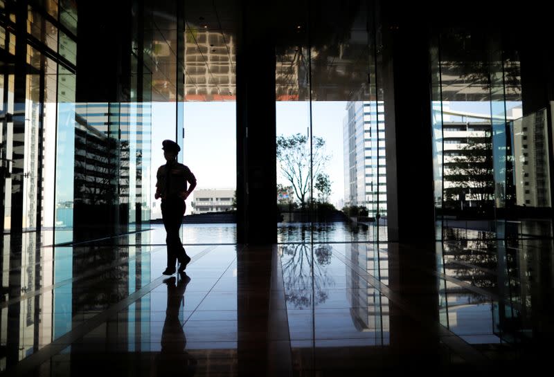 A security personnel walks as the entrance hall of SoftBank's new headquarters building in Tokyo