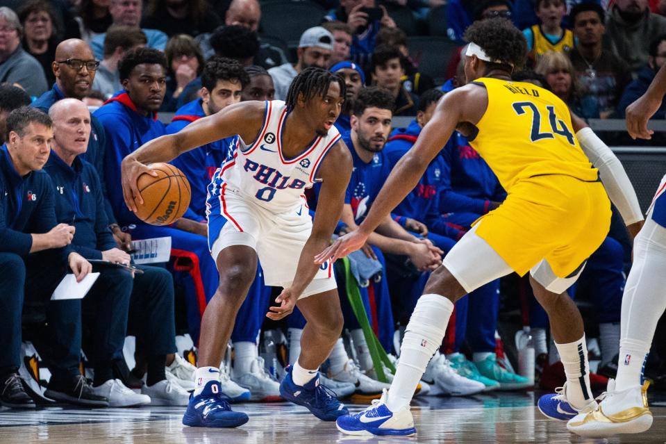 Mar 18, 2023; Indianapolis, Indiana, USA; Philadelphia 76ers guard Tyrese Maxey (0) dribbles the ball while Indiana Pacers guard Buddy Hield (24) defends in the first quarter at Gainbridge Fieldhouse.  ports